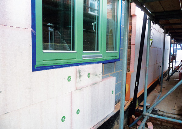 The house's external walls are insulated with a Permarock system including 180mm of phenolic foam insulation. Windows sit proud of the blockwork to ensure a continuous insulation layer.