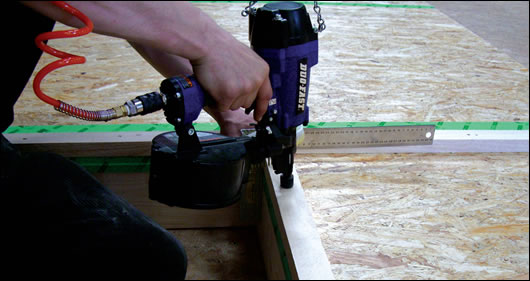 A worker in Continental Homes’ factory building timber sections with nails and thereby reducing the use of glues A worker in Continental Homes’ factory building timber sections with nails and thereby reducing the use of glues