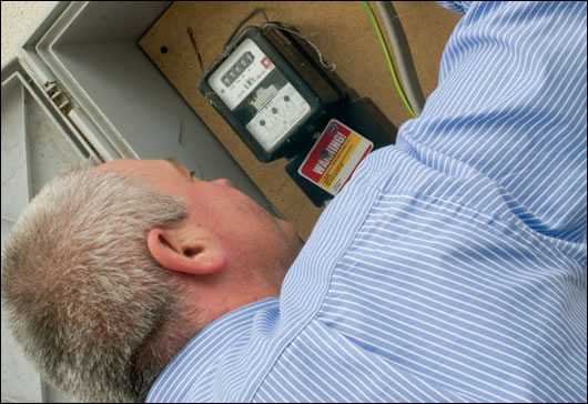 Stephen Harte checking the meter box to try to see what sort of insulation is in the cavity Stephen Harte checking the meter box to try to see what sort of insulation is in the cavity