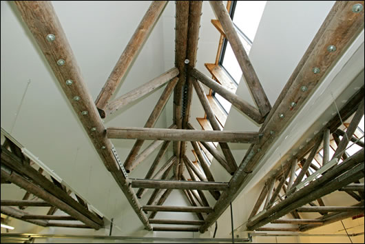 The timber trusses that span the width of the ceiling in the factory floor and storage area are made from FSC-certified Latvian timber The timber trusses that span the width of the ceiling in the factory floor and storage area are made from FSC-certified Latvian timber