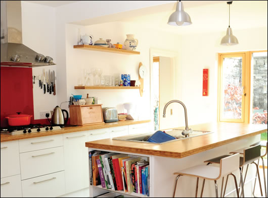 the natural light-flooded kitchen area, complete with bamboo worktops and salvaged timber flooring the natural light-flooded kitchen area, complete with bamboo worktops and salvaged timber flooring