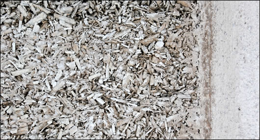 A small section at front of the house was not rendered with lime, leaving the set hempcrete mix exposed to show to those interested in learning about the method A small section at front of the house was not rendered with lime, leaving the set hempcrete mix exposed to show to those interested in learning about the method