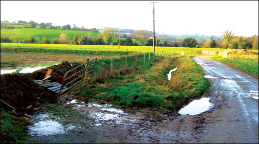 The ends of the percolation pipes within the flooded percolation area to the left extend into a surface water ditch which runs directly into a small water course about 40m away, resulting in a sewage fungus growth in the stream. The ends of the percolation pipes within the flooded percolation area to the left extend into a surface water ditch which runs directly into a small water course about 40m away, resulting in a sewage fungus growth in the stream.